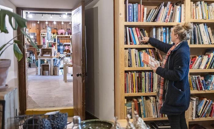 A visitor browsing a range of books on the shelves